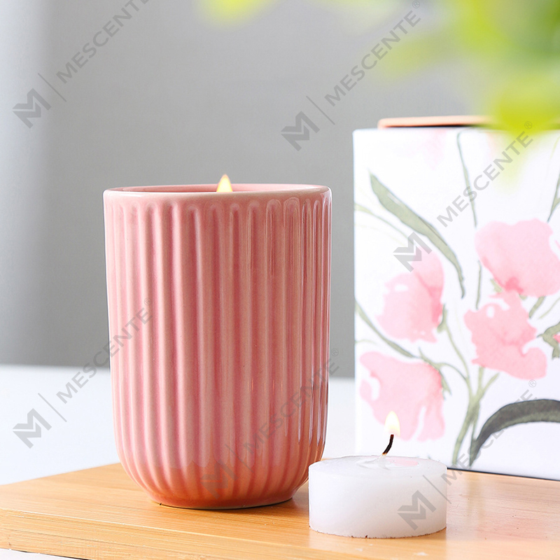 What are the primary differences in fragrance notes layering between luxury perfume scented candles and budget-friendly alternatives?